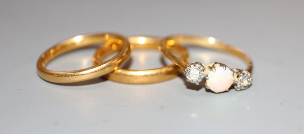 Two 22ct gold wedding bands, 6.6 grams and a yellow metal, white opal and diamond set three stone ring, size O, gross 1.9 grams.